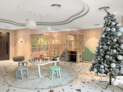 a living room with a christmas tree and a table and chairs at VayK - Luxury Living with Top Amenities 1BD in JVC in Dubai