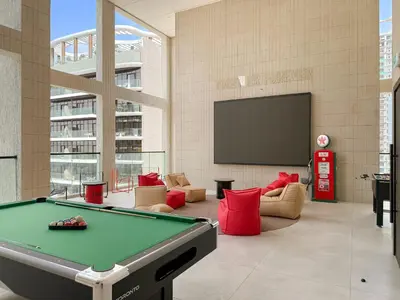 a room with a pool table and a tv at VayK - Luxury Living with Top Amenities 1BD in JVC in Dubai