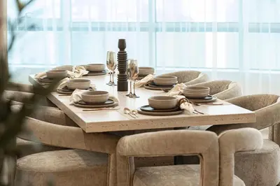 a dining room table with chairs and a wooden table and chairsktop at Elegantly crafted 5 Bedroom with Marina View in Dubai