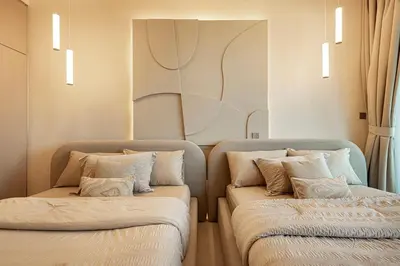two beds sitting next to each other in a room at Elegantly crafted 5 Bedroom with Marina View in Dubai