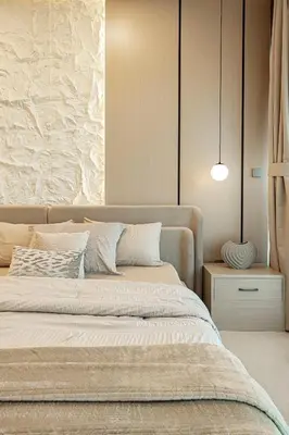 a bedroom with a large bed and a wall at Elegantly crafted 5 Bedroom with Marina View in Dubai