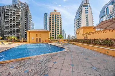 a swimming pool in a city with tall buildings at FiveX Premium 4BR Beachfront Living at JBR in Dubai