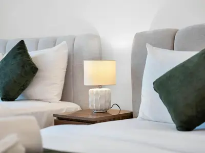 a bedroom with a bed and a lamp on a table at Cozy modern STUDIO in STERLING DOWNTOWN I DUBAI MALL I Sleeps 4 in Dubai