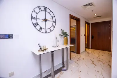 a large clock on a wall in a room at Luxury 3 BR Premium Feel Iconic Burj View Connected To Dubai Mall in Dubai