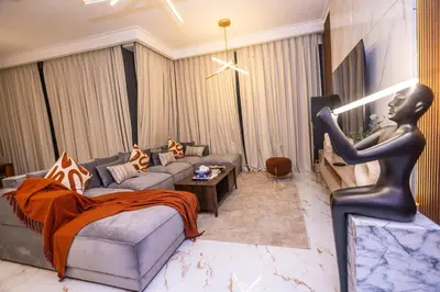 a living room with a statue of a woman at Luxury 3 BR Premium Feel Iconic Burj View Connected To Dubai Mall in Dubai