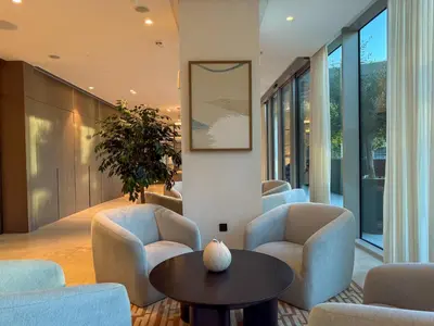 a living room with chairs and a table at Grande Signature Residences in Dubai