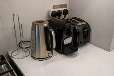 a toaster and a coffee maker on a counter at Grande Signature Residences in Dubai