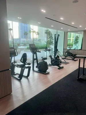a gym with treadmills and exercise equipment in a building at Stylish Dubai Stay, Pool, Padel, Gym, Concierge in Dubai