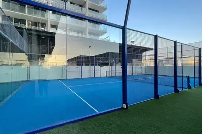 a tennis court in front of a building at Elite LUX Holiday Homes - Cozy Studio at Al Waleed Garden 2, Dubai in Dubai