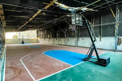 an empty gym with a basketball hoop at Elite LUX Holiday Homes - Cozy Studio at Al Waleed Garden 2, Dubai in Dubai