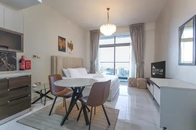 a bedroom with a bed and a table and chairs at Elite LUX Holiday Homes - Stylish Studio at Jewelz by Danube, Dubai in Dubai