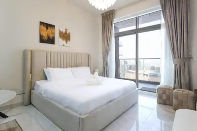 a bedroom with a large bed and a large window at Elite LUX Holiday Homes - Stylish Studio at Jewelz by Danube, Dubai in Dubai