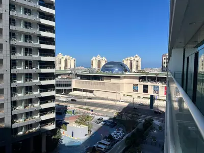 a view of a city with a building and a parking lot at Cozy Studio with Private Beach in Dubai