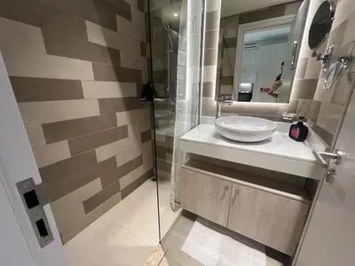 a bathroom with a sink and a mirror at Cozy Studio with Private Beach in Dubai