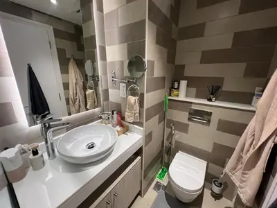 a bathroom with a sink and a toilet at Beach access, next to shopping mall in Dubai