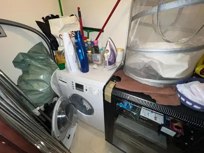a washing machine with a tank on top of it at Private beach, Close to Shopping Mall in Dubai
