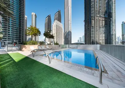 a swimming pool in the middle of a city with tall buildings at Forte Luxury 2BR Apartment with Skyline City Views near Dubai Mall in Dubai