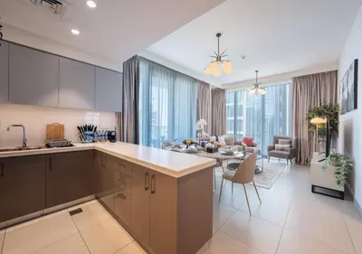 a kitchen and living room with a table and chairs at Forte Luxury 2BR Apartment with Skyline City Views near Dubai Mall in Dubai