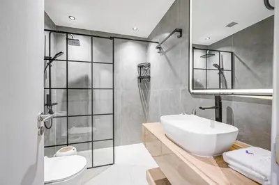 a bathroom with a white sink and a shower at Ample space 2BR Princess towers Marina in Dubai
