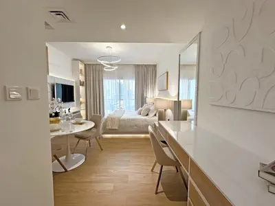 a hotel room with a bed and a table and chairs at Brand New Studio Downtown, All Bills Included in Dubai