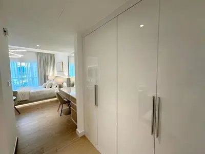 a white closet in a room with a bedroom at Brand New Studio Downtown, All Bills Included in Dubai