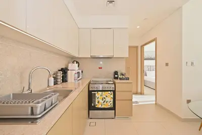 a kitchen with a sink and a stove at CH Skyline Bliss 1 BR near Burj Khalifa in Dubai