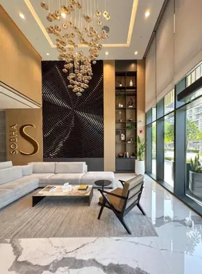 a living room with a couch and a chandelier at Brand New 1 Bedroom Apartment in Sobha Hartland Dubai in Dubai
