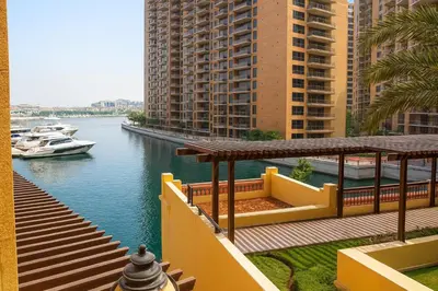 a view of a river with buildings and a boat at Luxury Apartment in Palm Jumeirah, Breathtaking Sea Views in Dubai