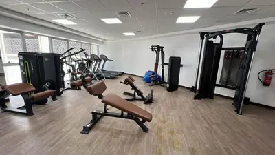 a gym with several treadmills and tread machines at The Cozy Corner Studio In Chaimaa in Dubai
