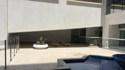 a courtyard of a building with a potted plant at The Cozy Corner Studio In Chaimaa in Dubai