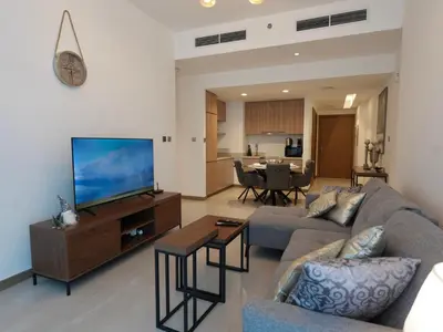 a living room with a couch and a flat screen tv at Urban Oasis by Missoni in Dubai