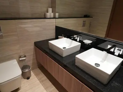 a bathroom with two sinks and a toilet at Urban Oasis by Missoni in Dubai