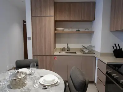 a kitchen with a table and chairs and a kitchen with a sink at Urban Oasis by Missoni in Dubai