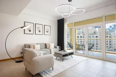 a living room with a couch and a table at Spacious 1B in Palm Close to Palm Mall in Dubai