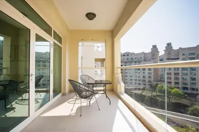a balcony with a table and chairs on it at Spacious 1B in Palm Close to Palm Mall in Dubai