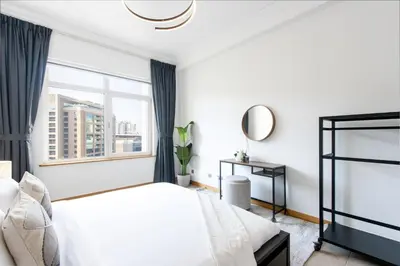 a bedroom with a bed and a window at Spacious 1B in Palm Close to Palm Mall in Dubai