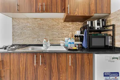 a kitchen with a sink and a microwave at Chic Studio in JVC near Stadium and Miracle Garden in Dubai