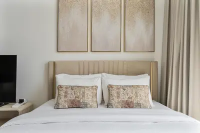 a bedroom with a bed with two pillows at Chic Studio in JVC near Stadium and Miracle Garden in Dubai