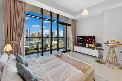 a bedroom with a large bed and a large window at Dubai Business Bay Modern Cozy Studio with Skyline Views & Lagoon Pool Access in Dubai