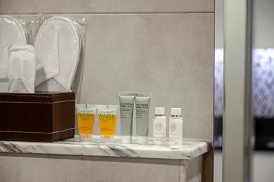 a shelf with a bunch of products on a bathroom counter at Dubai Business Bay Modern Cozy Studio with Skyline Views & Lagoon Pool Access in Dubai