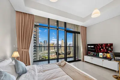 a bedroom with a bed and a large window at Dubai Business Bay Modern Cozy Studio with Skyline Views & Lagoon Pool Access in Dubai