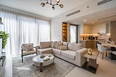 a living room with a couch and a table at Homes Beyond l Marina Luxe 1BR at LIV in Dubai