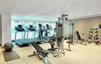 a gym with several treadmills and exercise machines at Hilton Garden Inn Dubai, Mall Avenue in Dubai