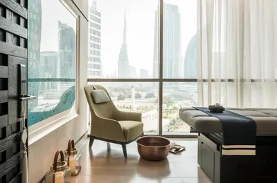 a hotel room with a bed and a chair and a window at Four Seasons Hotel Dubai International Financial Centre in Dubai