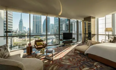 a bedroom with a bed and a view of a city at Four Seasons Hotel Dubai International Financial Centre in Dubai