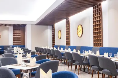 a dining room with tables and chairs in a room at MD Hotel By Gewan in Dubai