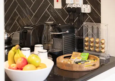 a kitchen counter with a bowl of fruit and a coffee maker at Luxury Sea View Beachfront 3 Bedroom Apt, JBR in Dubai