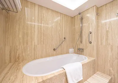 a bathroom with a white tub and a shower at Luxury Sea View Beachfront 3 Bedroom Apt, JBR in Dubai