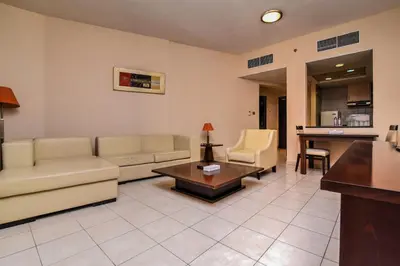 a living room with a couch and a table at Parkside Hotel Apartment in Dubai
