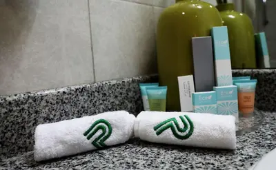two rolled towels on a counter in a bathroom at Parkside Hotel Apartment in Dubai